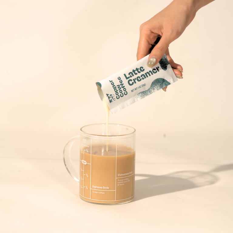 Copper Cow Coffee latte creamer poured into a mug