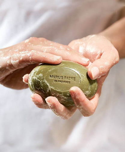 Hands lathering Marius Fabre oval olive oil Marseille soap, 150 g